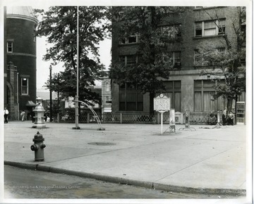 The courtyard square with a fountain and trees. A historic monument dedicated to Waitman Willey, Alexander I. Wade, and Dr. I.C. White, three prominent men who made prominent gifts to the world. Mr. Willey helped set up the state of West Virginia. Mr. Wade demonstrated a system for graded schools. And Mr. White was a leader in the field of geology.