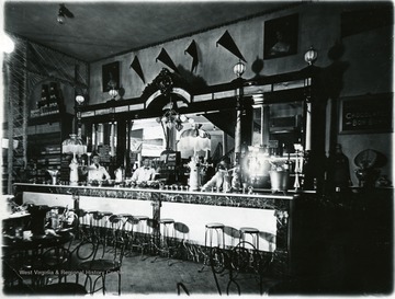 Soda jerks behind the counter at the Moore and Parriot Drugstore, Morgantown, W. Va.