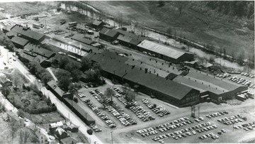 Sterling Faucet Company, located in Morgantown, W. Va. Automobiles parked outside of company. Few houses located near factory. 