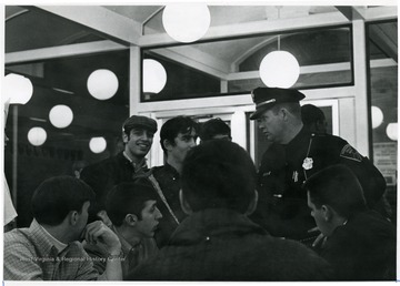 BBF was a burger shop in Morgantown.  A Morgantown police officer is talking to a man in the crowd.