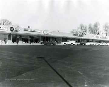 Suncrest Shopping Center located in Morgantown, W. Va. Automobiles parked in parking lot of shopping center. 