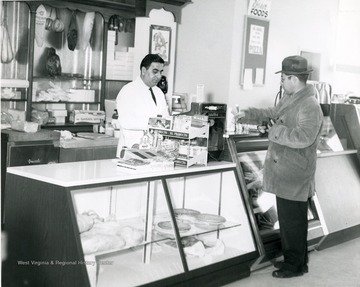 Located in the Suncrest Shopping Plaza in Morgantown, W. Va. Sam George in white behind counter.