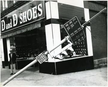 Store was located on the corner of High St. and Walnut St.' Street Sign and stoplight appears to have been knocked over.