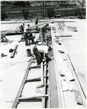 Men cementing the outside edge of Marilla pool, Morgantown, W. Va.