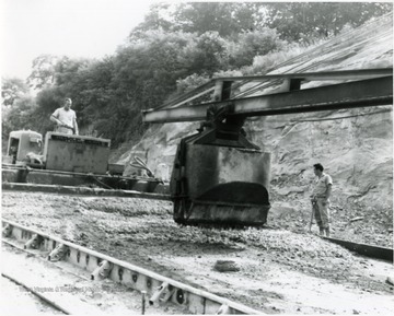 Two men working on the construction of a four lane highway south of Morgantown, W. Va. 