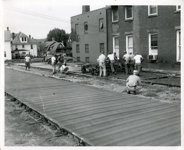 Construction workers are building a parking lot on Spruce and Pleasant Streets in Morgantown, West Virginia.