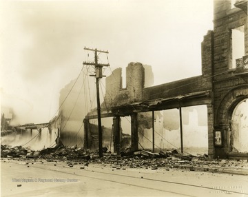 Remains of the Strand Theatre after fire. Debris spills onto sidewalk and into the street. 