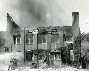 Smokes rises from the Moore Electric Building in Sabraton, near Morgantown, W. Va. Water is being used to help extinguish the flame. 