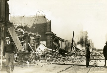 Debris seen on the sidewalk and in the road left from a fire at the old Strand Theatre in Morgantown, W. Va. 