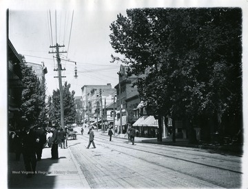 Townspeople are crossing High Street in Morgantown, West Virginia. 