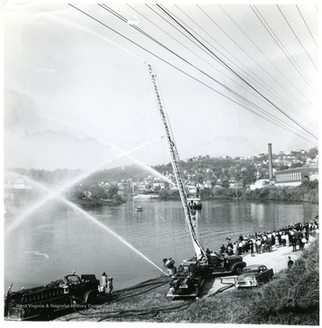 'Morgantown fire dept. helps welcome the centennial showboat Rhododendron to town.'