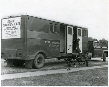 A lady and a child exit the State Department of Health Mobile X-ray unit in Morgantown, W. Va.