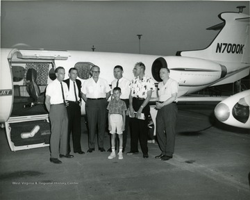 Two of the people in this photo are Martin Piribek, second from right and Mr. Courtney, third from left.  Lear jet 23, number N7000K.