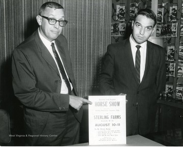 Ed Walls and an unidentified man are holding up a sign about the Quarter and English Horse Show which is at the Sterling Farms in Reedsville, West Virginia.