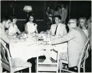 Couples sit around a table in the Hotel Morgan.