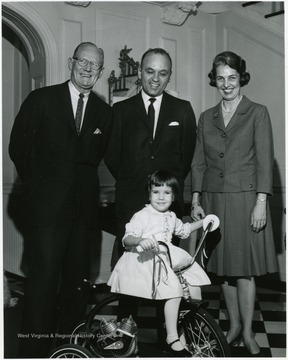 On the Left, Robert N 'Red' Brown, Director of Athletics at West Virginia University. Family may be that of one of his coaches.