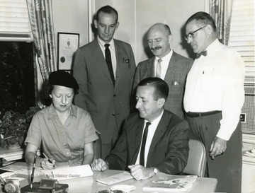 'Ward Stone is the man seated'. 