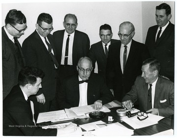 Sitting center is John Sherlacher.  Standing second from the left is John Ludlam.