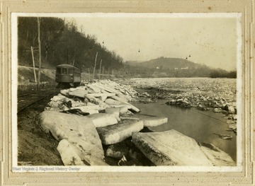 'Car number 52. Running West between Granville and Jimtown (Randell). Beside Monongahela River. The buckets suspended above the river were used to carry coal from a mine on the West-side to the Baltimore and Ohio Rail Road shipping point on the East-side. 