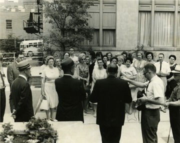 Right to left, with backs to camera:  Earl Fisher, Jack Johns, Charles Stevenson, Sheriff Charles Whiston, and Robert Nestor at the speech on Courthouse Square.