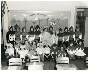 Student group dressed as flowers and assorted animals for a spring celebration 