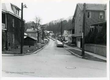 A man is walking on the sidewalk of Falling Run Road in Morgantown, West Virginia.