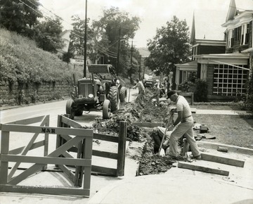 Road crew members are working on University Avenue in Morgantown, West Virginia.