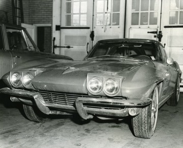 Two automobiles are parked in front of a garage in Morgantown, West Virginia.