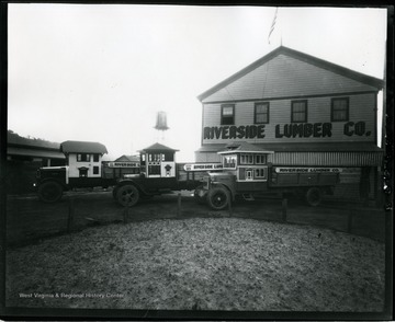 Three delivery trucks are outside in front of Riverside Lumber Company in Morgantown, West Virginia.