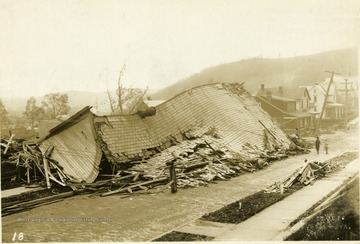 Building destroyed during a windstorm.  Roof of building is on the street.