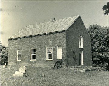 An exterior view of the Christ Church in Bunker Hill. 'Grave of Morgan Morgan to the rear of the edifice.'