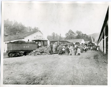 Townspeople are gathered in front of a train at the Burt Tannery in Mannington, in Marion County, West Virginia.