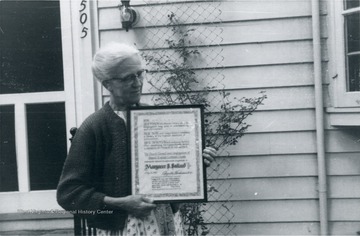 Margaret B. Ballard holds a testimonial from the Second English Lutheran Church.