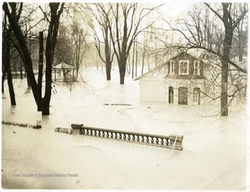 Flood waters engulf a house.