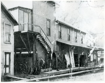 Supply store with wagon wheels stacked in front.  The Cairo Opera House is upstairs.