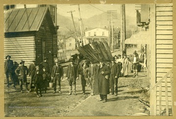 People standing on street after a flood in New Martinsville.