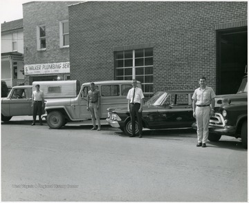 Pictured left to right; Richard Hurt, Albie Cross, Howard Spory (foreman), and Kenneth VonMeler.  All college students working this past summer as a change out crew.  They changed out manual sets to new dial sets.   