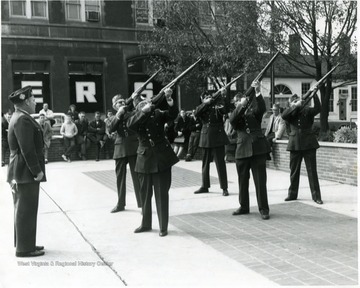 Soldiers pointing guns in the air for the Memorial Day service on Courthouse square.