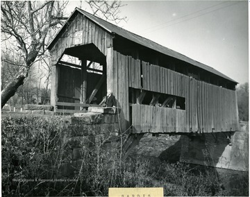 View of man standing at front of bridge.