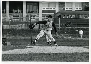 West Virginia University baseball pitcher is pitching during a baseball game.