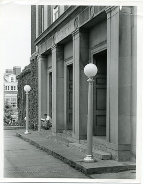 Student is reading on the front steps of the Chemistry Building, Clark Hall, West Virginia University.