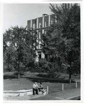 Couple is sitting in front of the Chemistry Building, Clark Hall, West Virginia University.