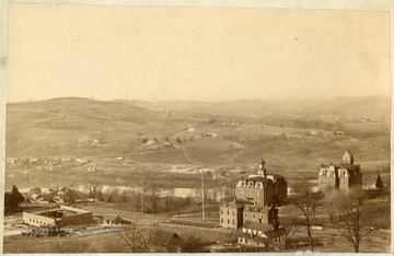 'West Virginia University, taken in late eighties, from present site of Women's Hall, showing Reynolds Hall or old Commencement Hall under construction, and front section only added to original Armory to make the Experiment Station.'