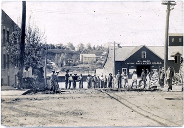 W.L. Wade Livery Sale and Feed Stable in the background.  Possible working on Walnut Street.