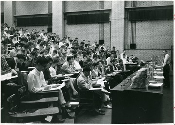 'In Chemistry Building auditorium before 1965 remodeling.  James Hall, Instructor.'