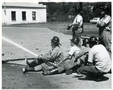 WVU Extension Fire School students using fire hose.