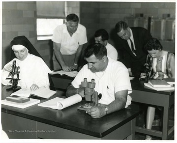 Standing Back Row, left to right; Jesse Clovis, Biology instructor (in white shirt) and Dr. James Hickman, Chemistry, with tie.