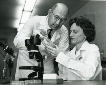 Dr. Gilbert and another physician examine a specimen.