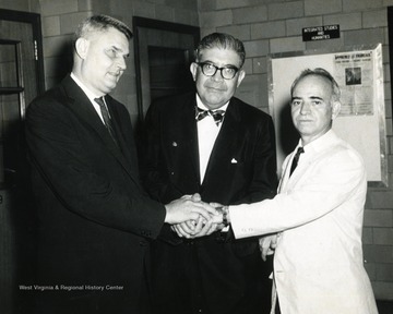 Robert Stilwell,left, Chairman Languages, German and Spanish; unidentified; Frank Herrera, right, Professor Spanish.