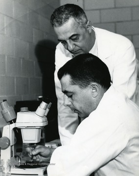 Professor of Medicine, Nicholas W. Fugo(standing), Instructor of Obstetrics and Gynecology, Dr. Roy L. Butcher (sitting).